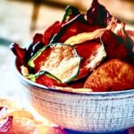 A bowl of homemade Veggie Chips, thinly sliced and crisp, showing a simple, easy low carb vegan snack.